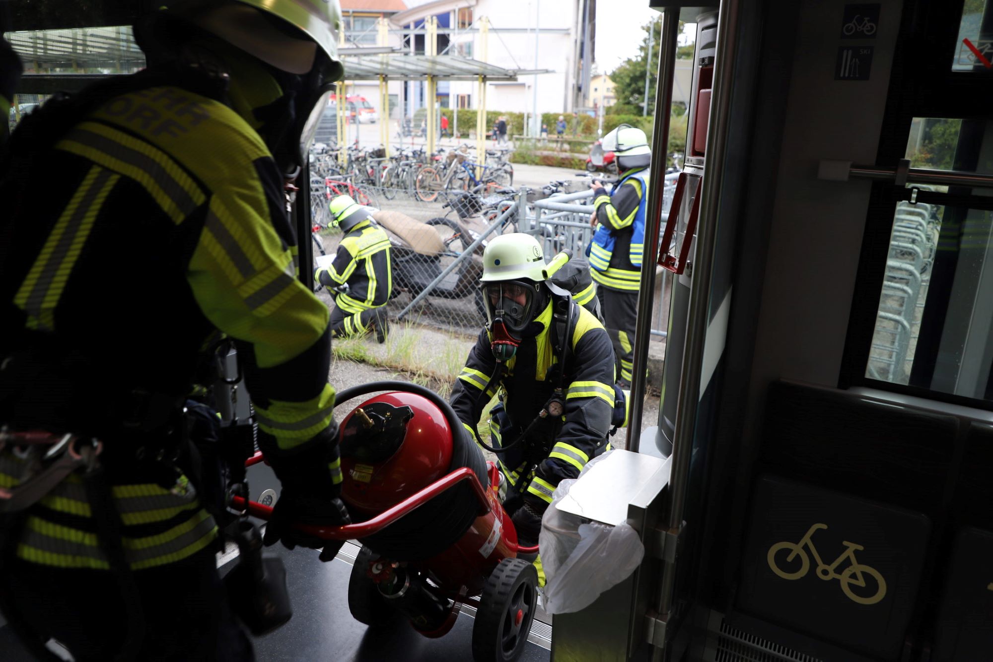 Atemschutzträger bringen einen fahrbaren Pulverlöser zur Einsatzstelle.JPG